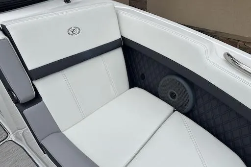 Slide: The Image of 2024 Cobalt R8 boat interior with white cushioned seating and integrated speaker. - 23