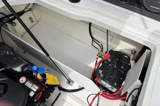 Slide: The Image of 2024 Cobalt R8 boat engine compartment with battery and wiring. - 27
