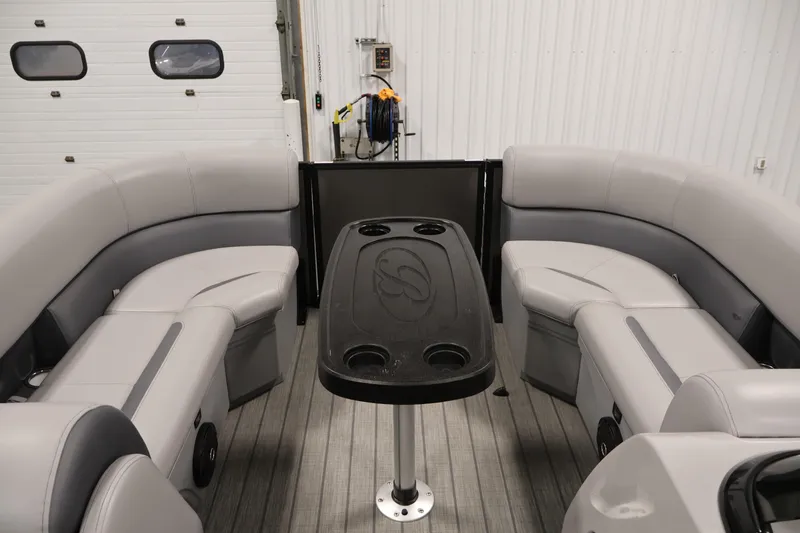 Slide: The Image of 2025 Bentley Pontoons 223 Swingback interior with gray seating and central table. - 11