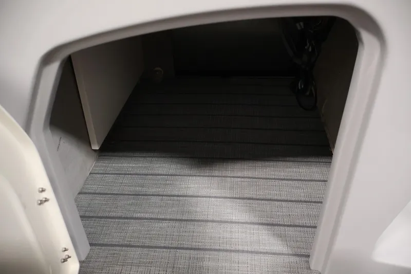 Slide: The Image of Interior view of 2025 Bentley Pontoons 223 Swingback, showcasing flooring and storage space. - 19