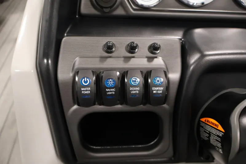 Slide: The Image of Control panel of 2025 Bentley Pontoons 223 Swingback with labeled switches for lights and power. - 23