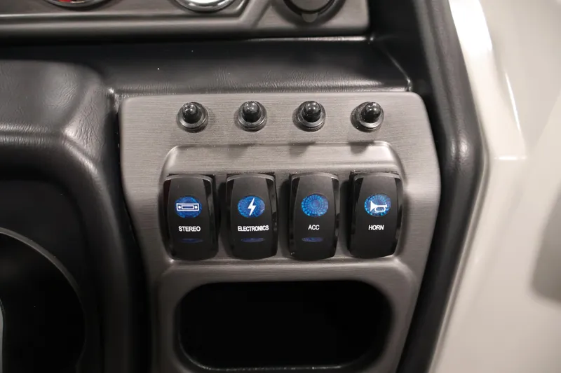 Slide: The Image of Control panel of 2025 Bentley Pontoons 223 Swingback with labeled switches for stereo, electronics, accessories, and horn. - 24