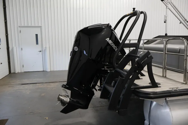Slide: The Image of 2025 Bentley Pontoons 223 Swingback with Mercury outboard motor in a garage setting. - 36