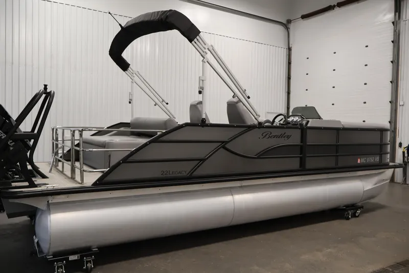 Slide: The Image of 2025 Bentley Pontoons 223 Swingback in a showroom, showcasing sleek design and modern features. - 4