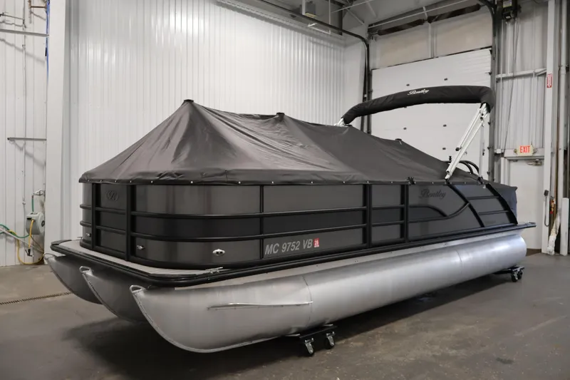 Slide: The Image of 2025 Bentley Pontoons 223 Swingback with cover in a garage setting. - 40