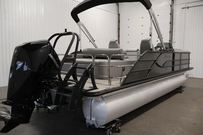 Slide: The Image of 2025 Bentley Pontoons 223 Swingback with Mercury engine in a showroom setting. - 5