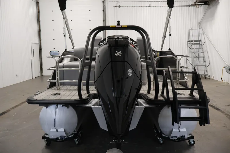 Slide: The Image of 2025 Bentley Pontoons 223 Swingback in a showroom, showcasing sleek design and powerful engine. - 6