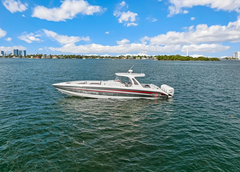 The Image of 2015 Cigarette 41' GTR boat on calm water under clear sky. - 0