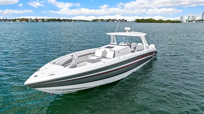 Slide: The Image of 2015 Cigarette 41' GTR boat on calm water. - 2