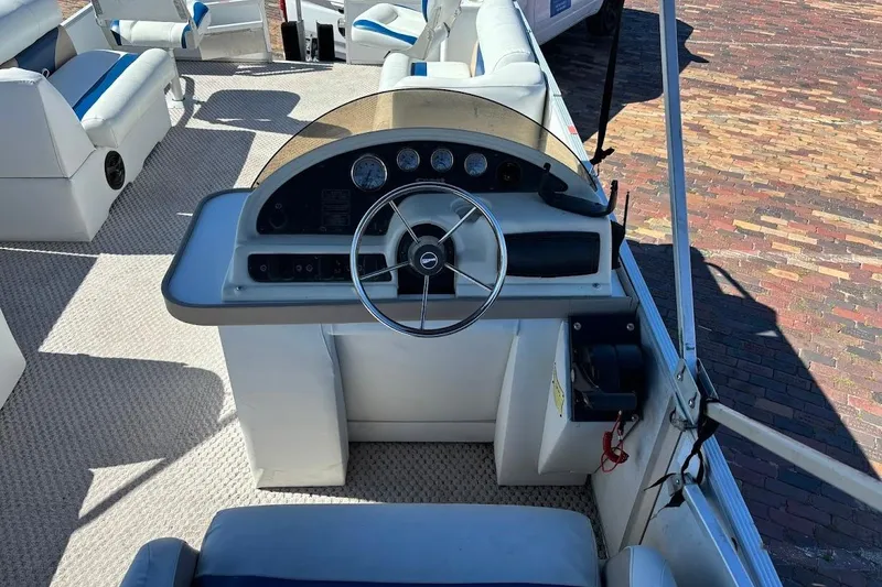 Slide: The Image of 2004 Crest 2200 Family DL boat interior with steering console and seating. - 15