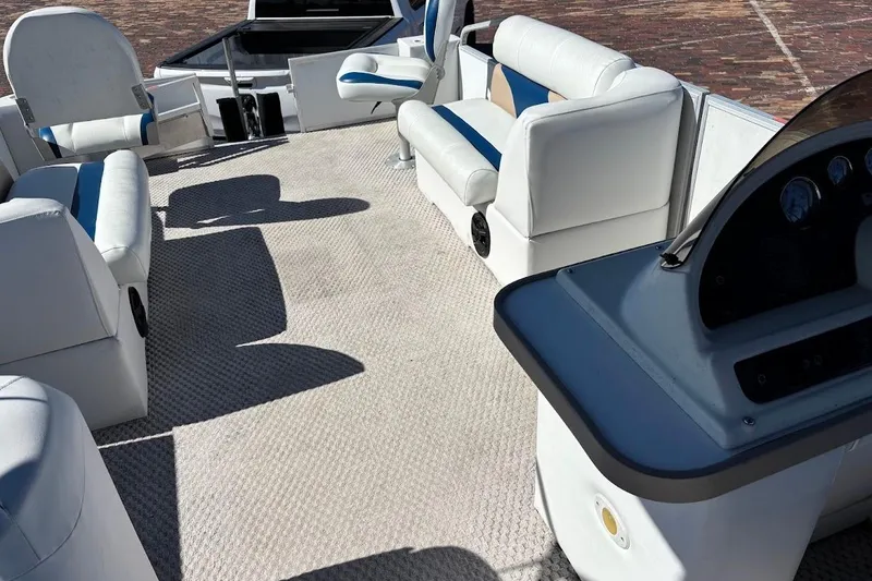 Slide: The Image of 2004 Crest 2200 Family DL pontoon boat interior with white seating and carpet. - 16