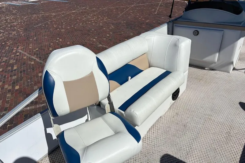 Slide: The Image of 2004 Crest 2200 Family DL boat seats with white, blue, and beige upholstery on deck. - 20