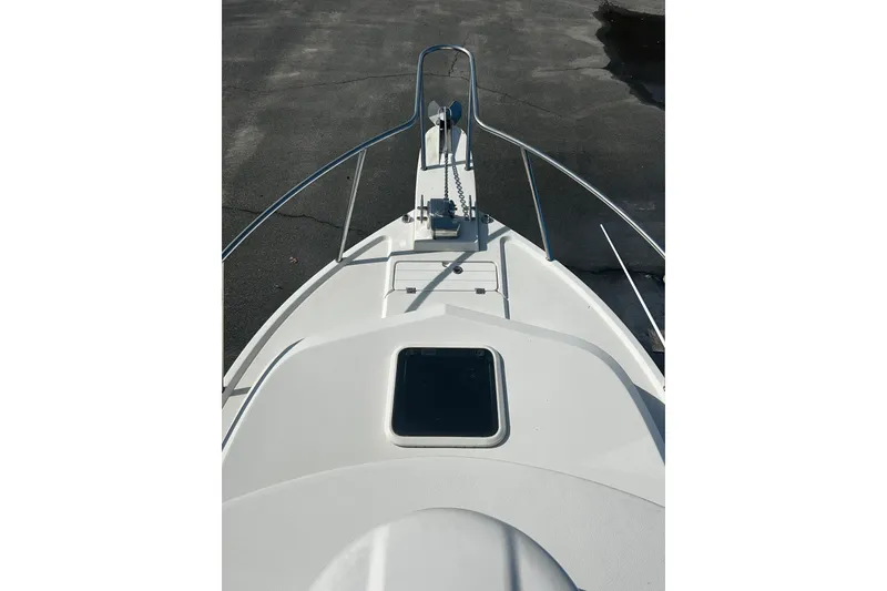 Slide: The Image of Bow view of 2019 Parker 2320 Sport Cabin boat, featuring sleek design and sturdy railings. - 12