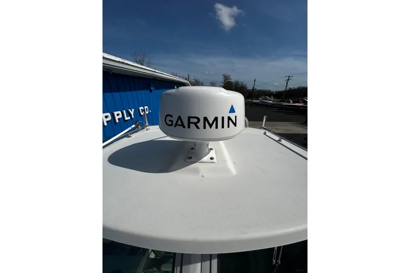 Slide: The Image of Garmin radar on 2019 Parker 2320 Sport Cabin boat under clear blue sky. - 13