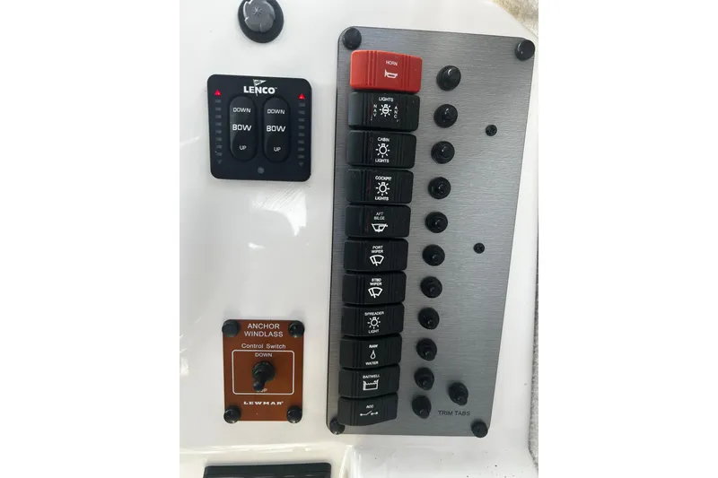 Slide: The Image of Control panel of a 2019 Parker 2320 Sport Cabin boat with various switches and buttons. - 22