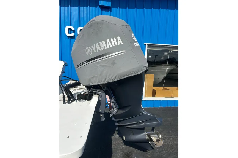 Slide: The Image of Yamaha outboard motor on a 2019 Parker 2320 Sport Cabin boat, blue building background. - 24