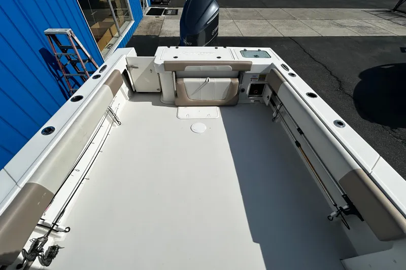 Slide: The Image of 2019 Parker 2320 Sport Cabin boat deck, spacious layout, rod holders, and seating. - 9