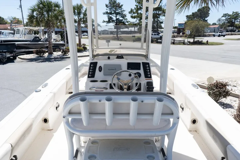Slide: The Image of 2017 Robalo 246 Cayman boat interior with steering console and rod holders. - 10