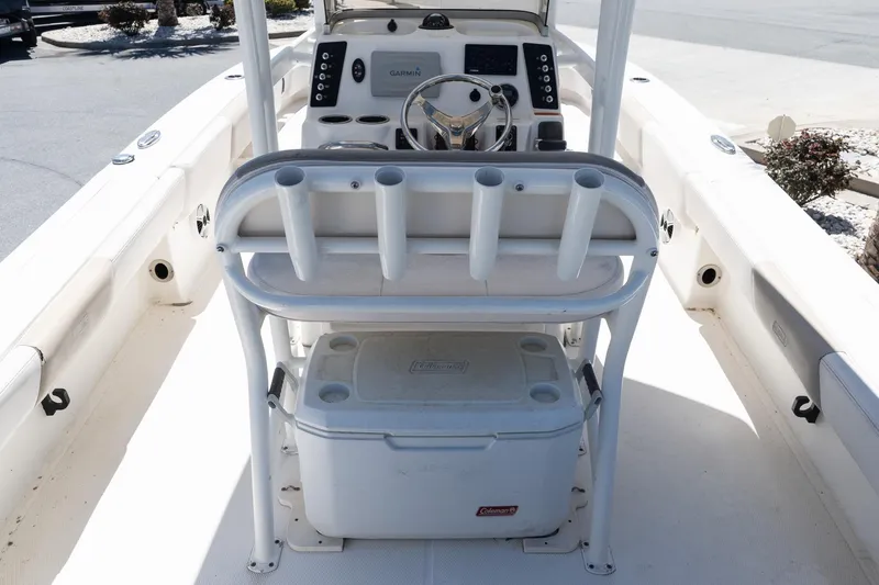 Slide: The Image of 2017 Robalo 246 Cayman boat interior with steering console and rod holders. - 11