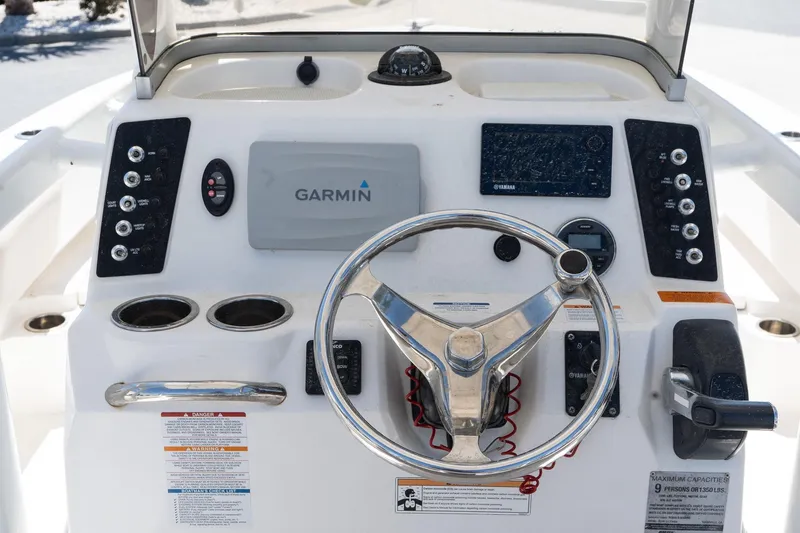Slide: The Image of 2017 Robalo 246 Cayman boat dashboard with Garmin navigation system and steering wheel. - 12