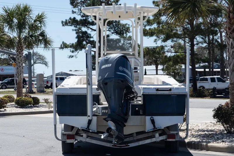 Slide: The Image of 2017 Robalo 246 Cayman boat with Yamaha engine on trailer, parked near palm trees. - 5