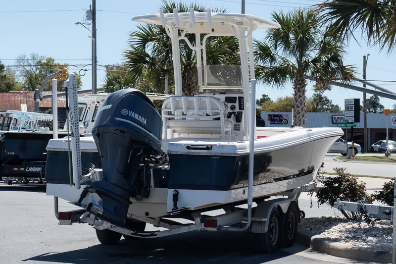 Slide: The Image of 2017 Robalo 246 Cayman boat on trailer with Yamaha engine, parked outdoors. - 6
