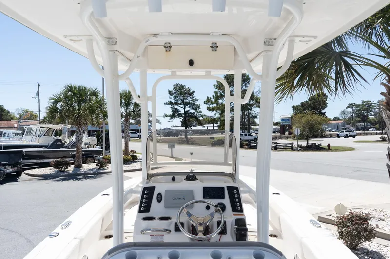 Slide: The Image of 2017 Robalo 246 Cayman boat interior with steering console, parked outdoors. - 9