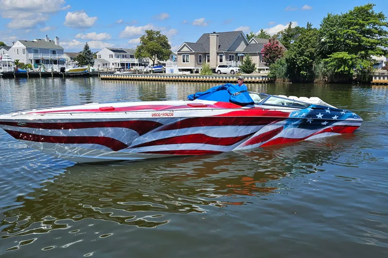 The Image of 2004 Formula 382 FASTech boat with American flag design on a calm waterway. - 0