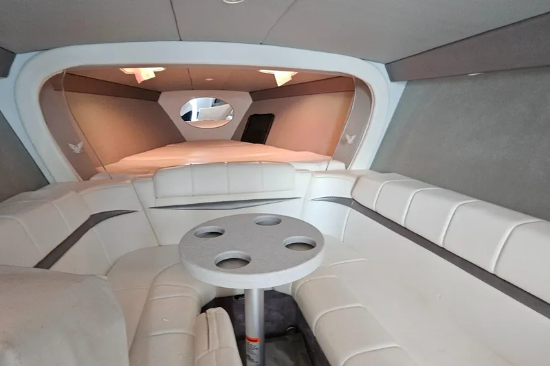 Slide: The Image of 2004 Formula 382 FASTech boat interior with white seating and round table. - 22