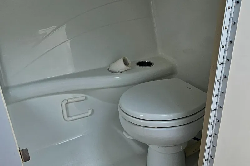 Slide: The Image of 2004 Formula 382 FASTech boat bathroom with white toilet and compact design. - 23