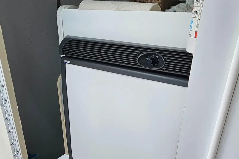 Slide: The Image of 2004 Formula 382 FASTech interior fridge with black trim and control knob. - 25