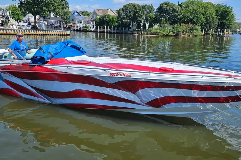 Slide: The Image of 2004 Formula 382 FASTech boat with American flag design on a calm lake. - 28