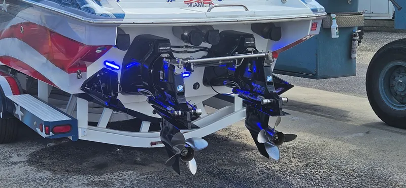 Slide: The Image of Rear view of a 2004 Formula 382 FASTech boat with dual propellers and blue lighting. - 8