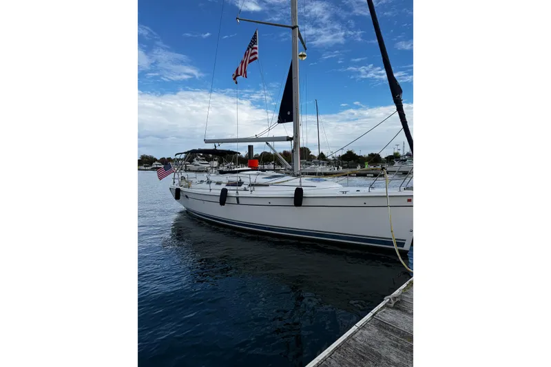 The Image of Sailboat docked at marina, Hunter 38 model, 2007, with American flag. - 0