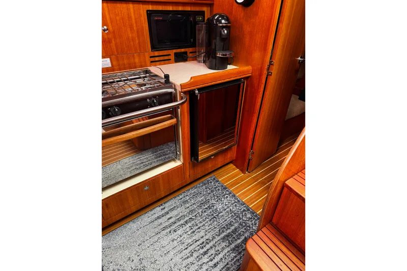 Slide: The Image of Wooden interior of a 2007 Hunter 38 yacht kitchen with stove and appliances. - 15