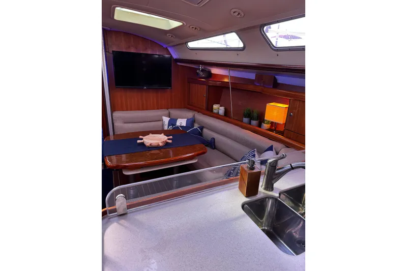 Slide: The Image of Interior of 2007 Hunter 38 sailboat with cozy seating and modern amenities. - 16