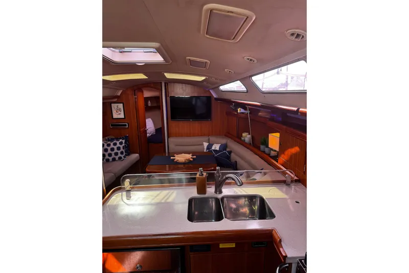 Slide: The Image of Interior of 2007 Hunter 38 sailboat with modern kitchen and cozy seating area. - 17