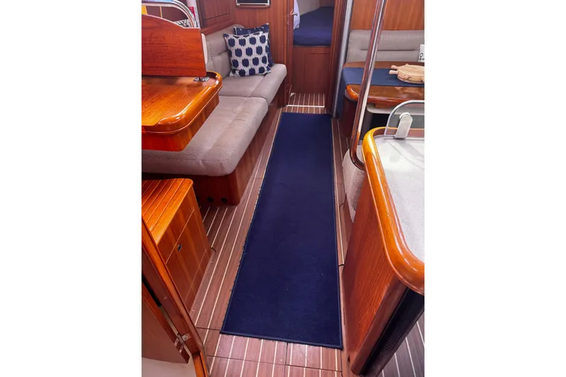 Slide: The Image of Interior of 2007 Hunter 38 sailboat with wooden finishes and blue carpet. - 19