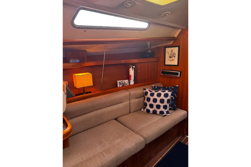 Slide: The Image of Cozy interior of 2007 Hunter 38 sailboat with cushions and decor. - 21