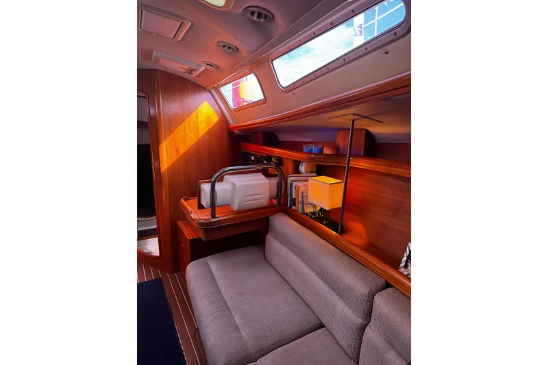 Slide: The Image of Interior of 2007 Hunter 38 sailboat with cozy seating and wooden accents. - 22