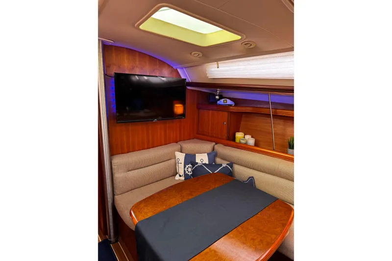 Slide: The Image of Cozy interior of 2007 Hunter 38 sailboat with seating, table, and TV. - 24