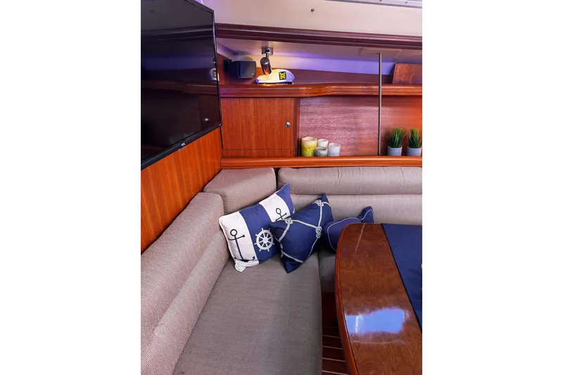 Slide: The Image of Interior of 2007 Hunter 38 yacht with nautical-themed cushions and wooden furnishings. - 25