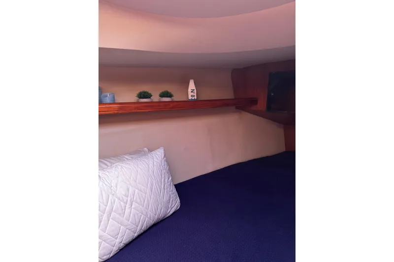 Slide: The Image of Cozy cabin interior of 2007 Hunter 38 sailboat with shelf and pillow. - 32