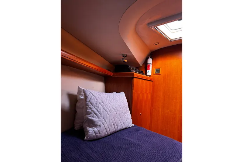 Slide: The Image of Cozy cabin interior of 2007 Hunter 38 sailboat with wooden paneling and skylight. - 33