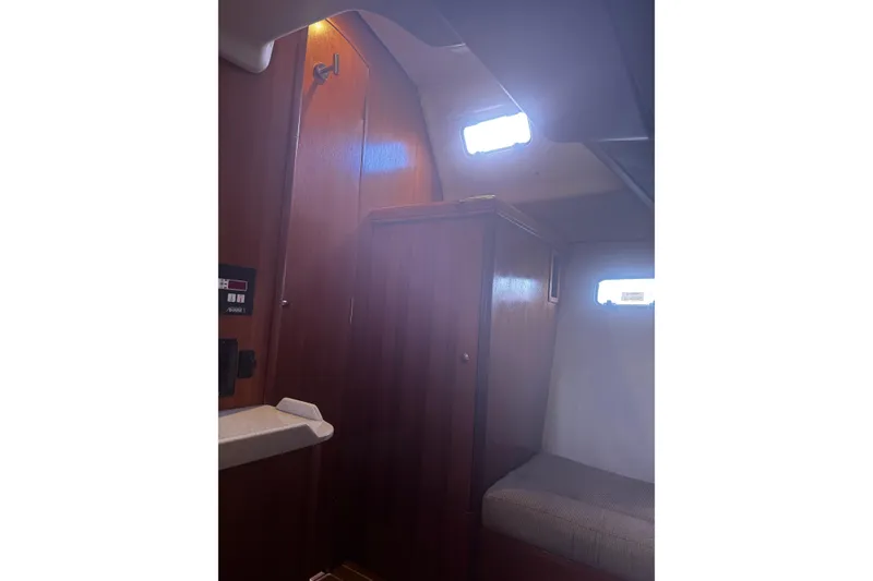 Slide: The Image of Interior of a 2007 Hunter 38 sailboat, featuring wooden cabinetry and seating. - 35