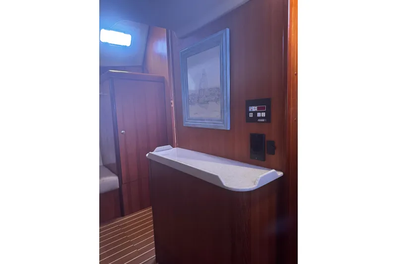Slide: The Image of Interior of 2007 Hunter 38 yacht with wood paneling and framed artwork. - 36