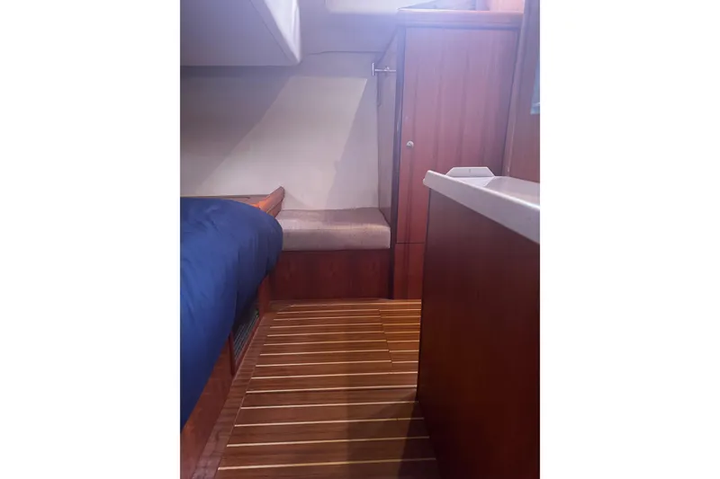 Slide: The Image of Interior of a 2007 Hunter 38 sailboat cabin with wooden flooring and cozy seating. - 37