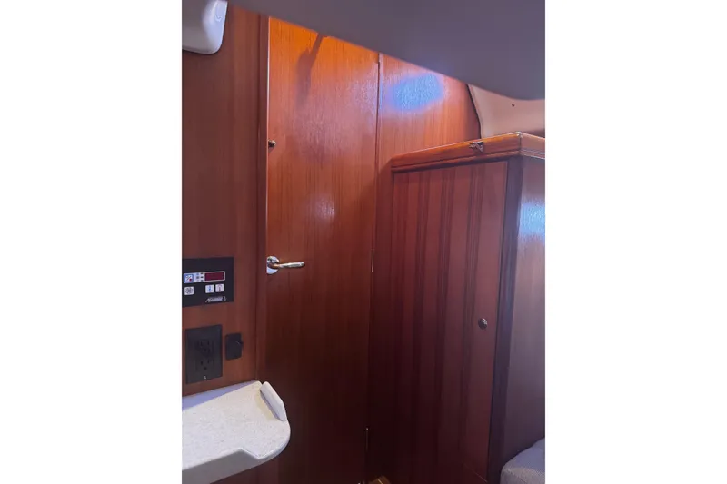Slide: The Image of Interior of 2007 Hunter 38 sailboat with wooden cabinetry and door. - 38