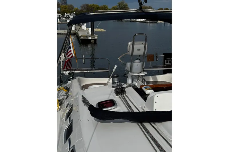 Slide: The Image of Sailboat deck view of 2007 Hunter 38 at marina with American flag. - 4