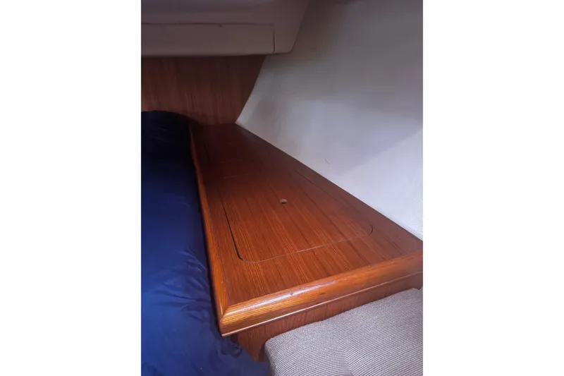 Slide: The Image of Interior cabin of 2007 Hunter 38 sailboat with wooden storage compartment. - 40
